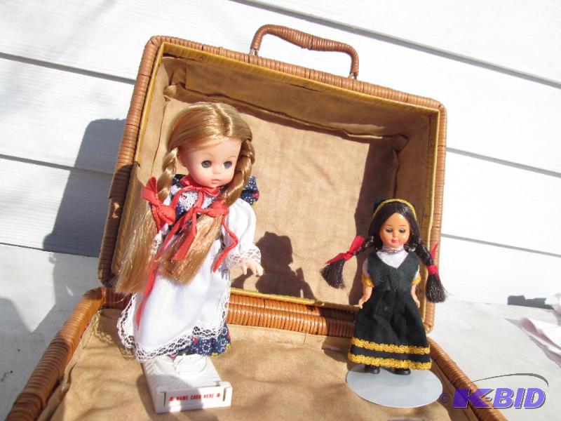 Pair of dolls on stand in a wood woven case...