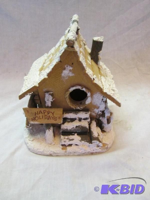 small wooden house with happy holiday sign in...