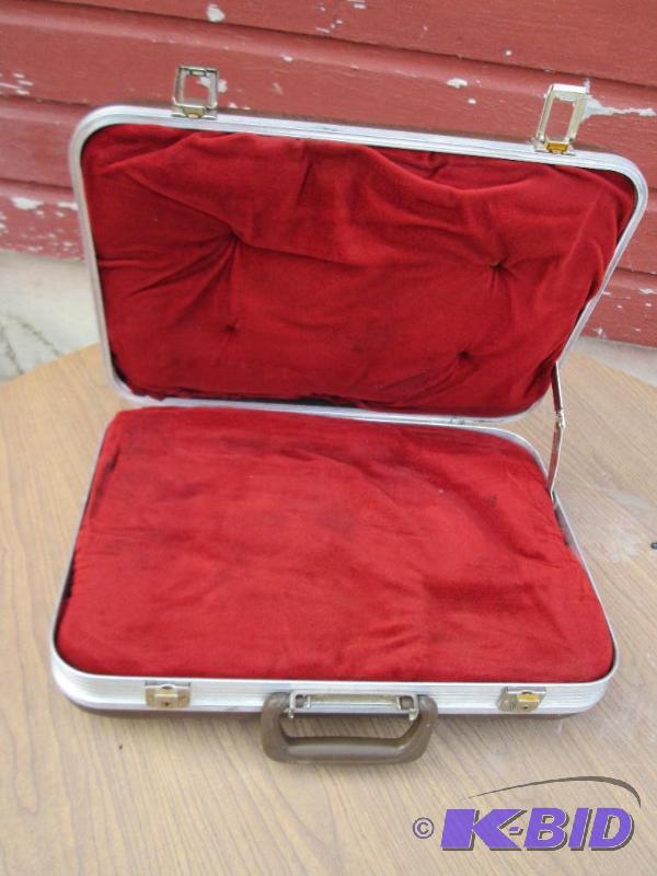 Hardshell pistol case with plush red padded i...