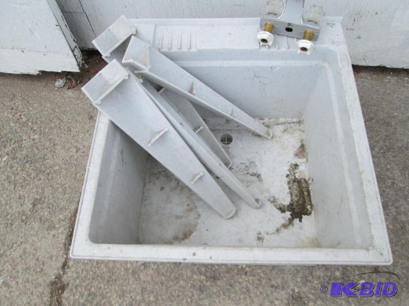Plastic wash tub sink with legs and a faucet,...