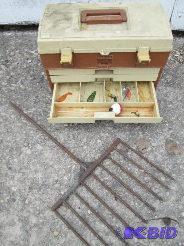 Fishing spear and a Plano tackle box with som...