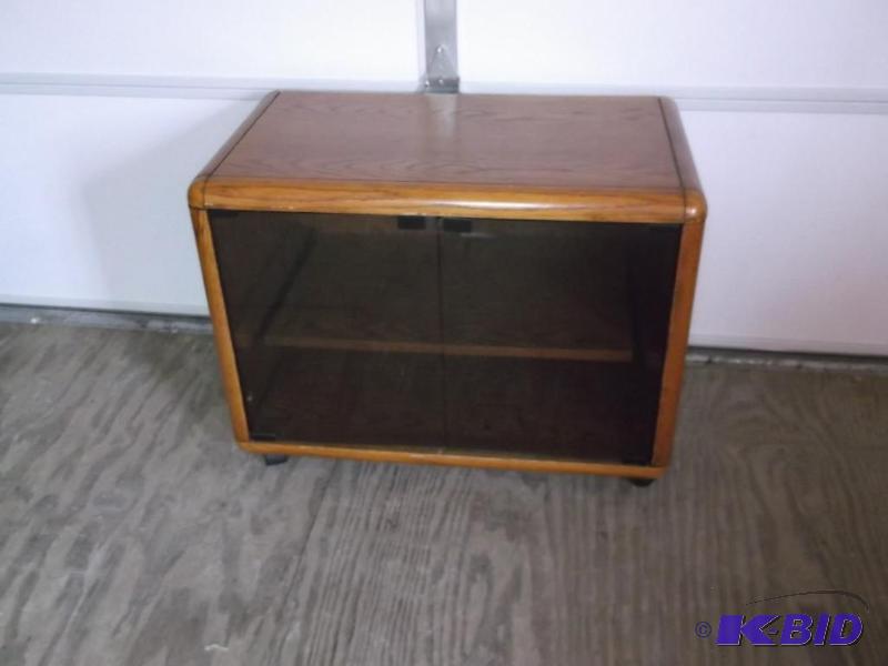 Oak glass front t.v stand on casters measurin...