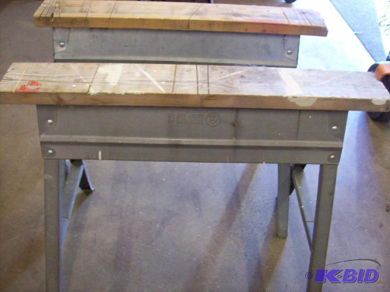 Two metal folding saw horses with 2x6 on top ...