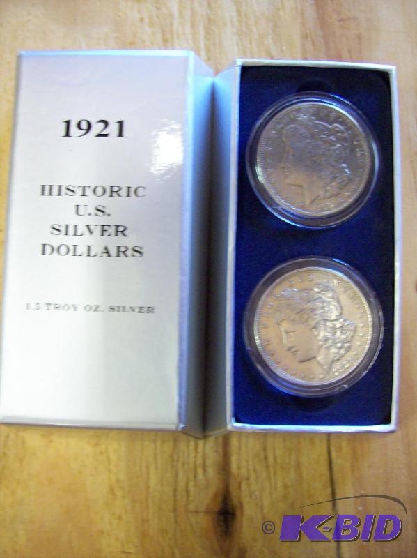 Two Morgan Dollars uncirculated in plastic pr...