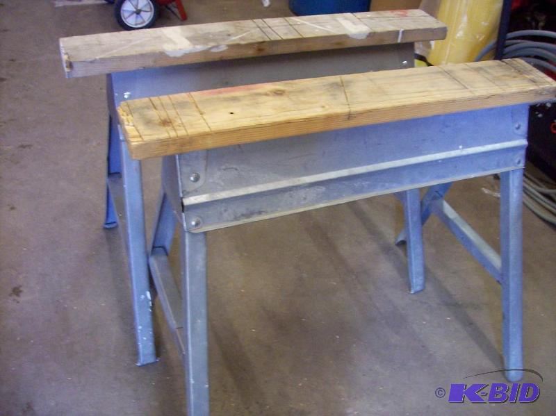 Two metal folding saw horses with 2x6 on top ...