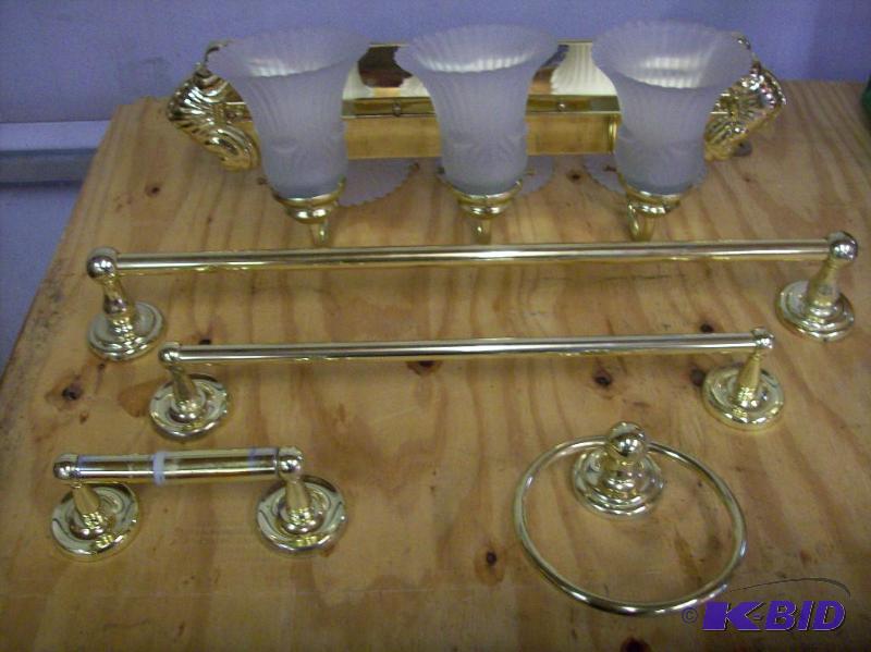 Bathroom fixtures in bright brass. One 24&quo...