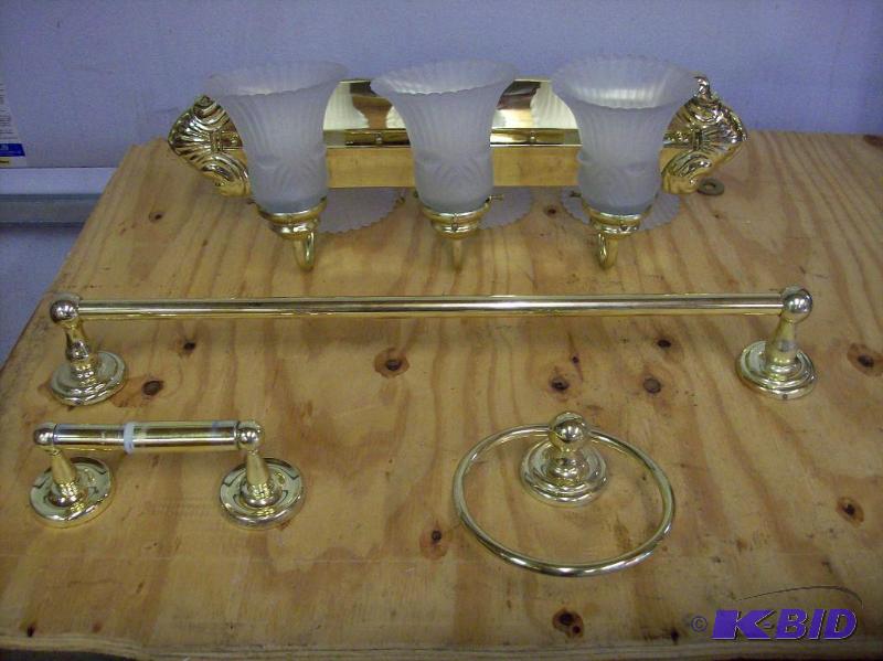Bathroom fixtures in bright brass. One 24&quo...
