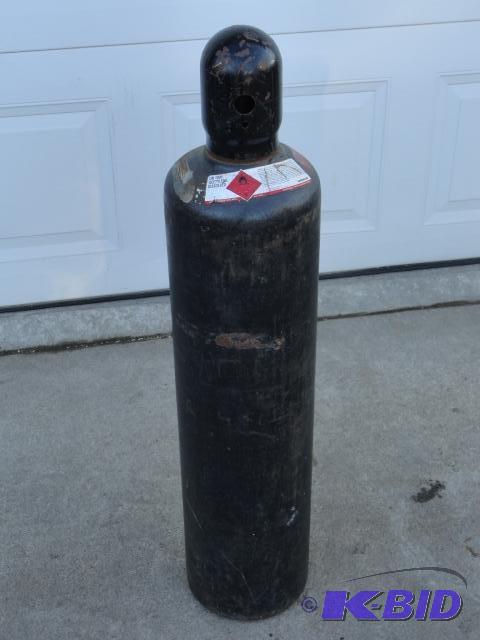 lot 28 image: Acetylene tank with cap, partial full...