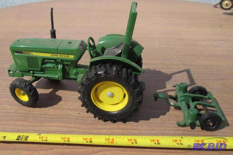 lot 65 image: John Deere tractor replica and attachment...