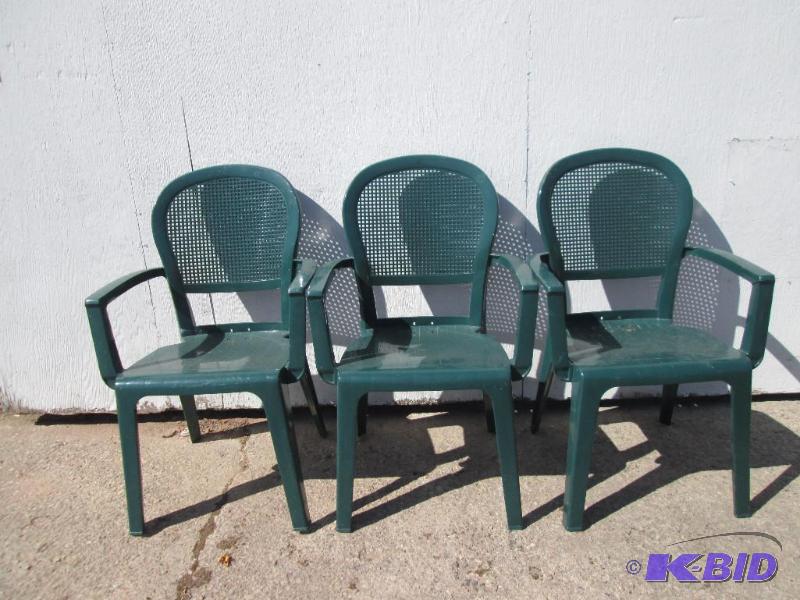 lot 69 image: 3 green plastic stacking chairs...
