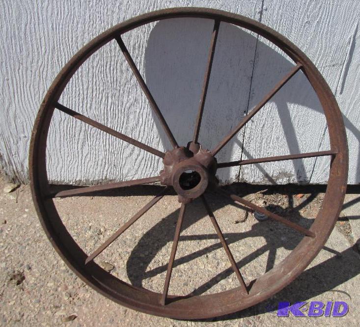 lot 82 image: All metal wheel rim, 24 inches across...