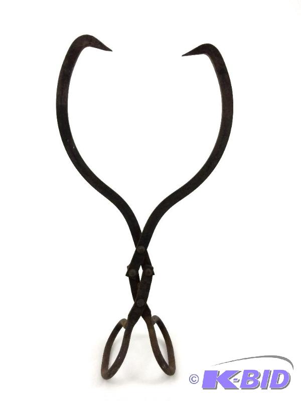 lot 25 image: Antique Ice Tool Or Cannon Ball Tong  Cast Iron Tongs.  17 in Length.