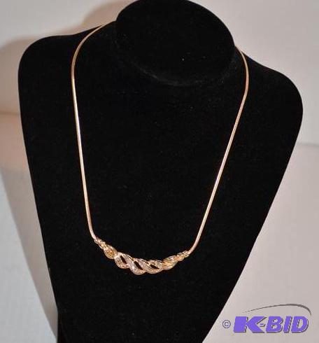 lot 28 image: 10K gold necklace with diamonds.. The diamond...