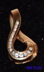 lot 29 image: 14K gold pendent with diamonds. Diamonds were...