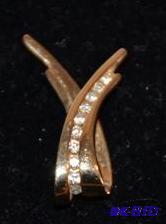 lot 30 image: 14K gold pendent with diamonds. The Diamonds ...
