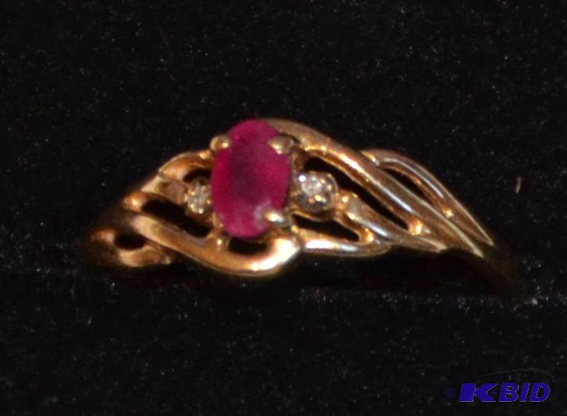 lot 35 image: 10K gold ring with possibly a ruby or garnett...