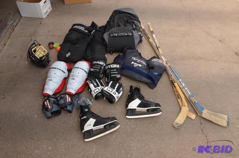 lot 39 image: Hockey gear - skates size 12, 4 sticks, pucks...