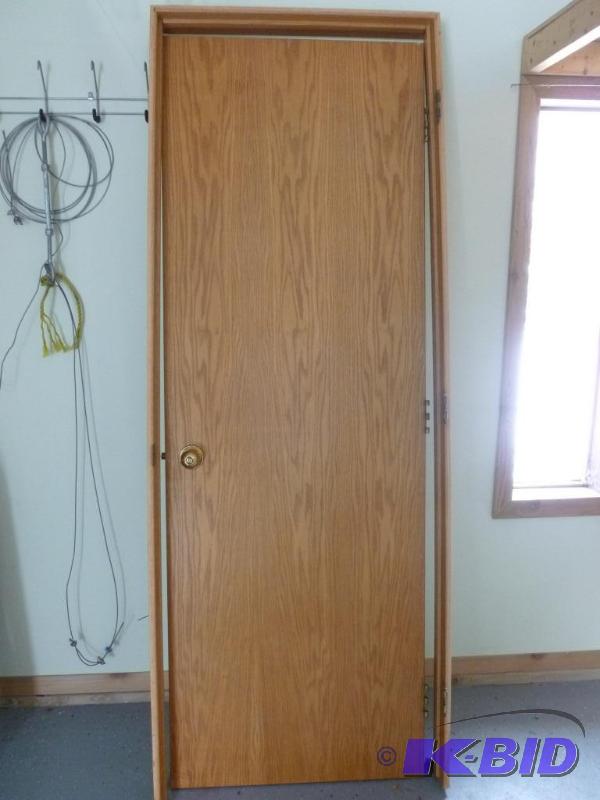 lot 56 image: Nice 28" oak grained interior door with ...