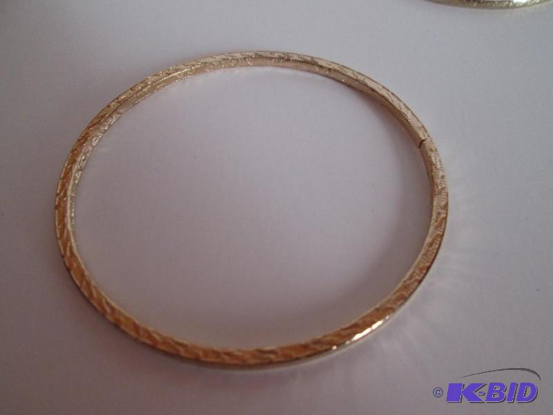 lot 116 image: Gold colored metal braclet with designs...