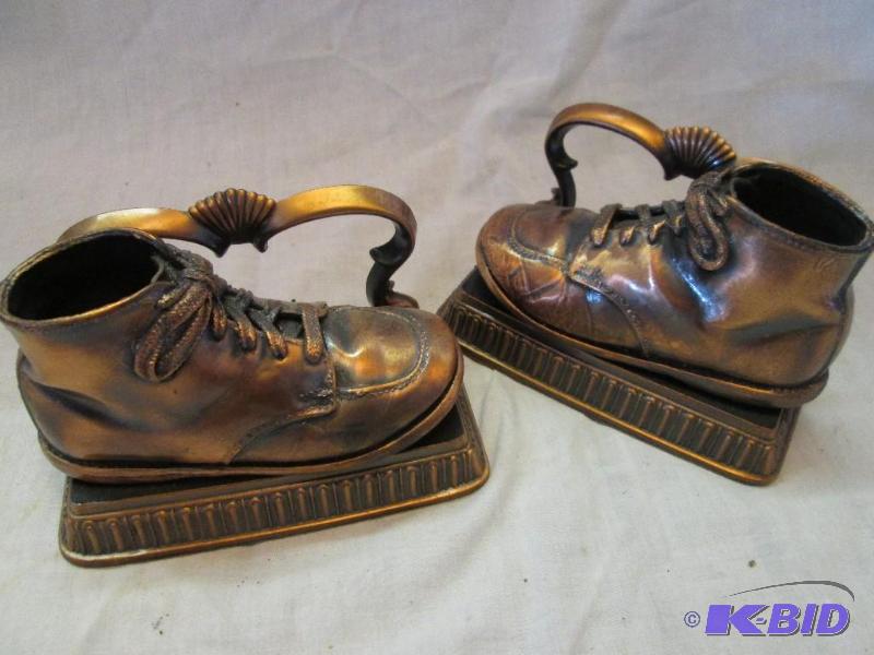 lot 12 image: Pair of shoe decorations on a stand, very int...