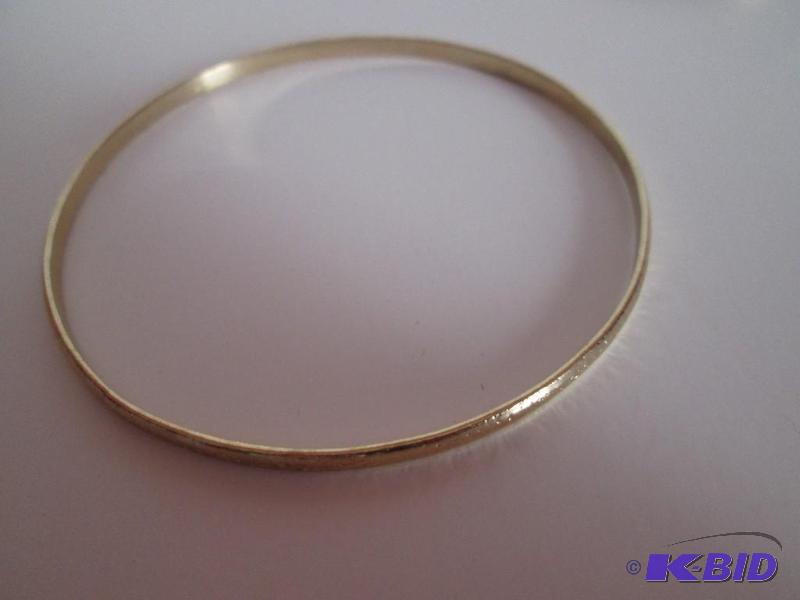 lot 120 image: Gold colored metal braclet with small design ...
