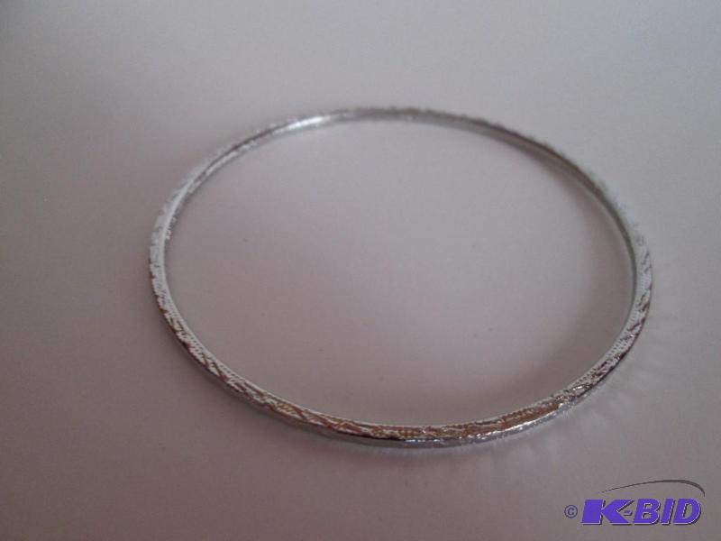 lot 126 image: sliver metal braclet with design outlining it...