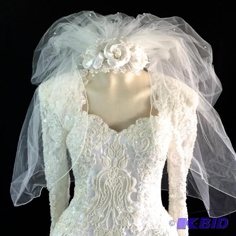 Newer heavily decorated wedding dress with long show stopping train comes with matching Veil..