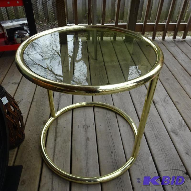 Brass finish end table. Glass top. 23 x 22...