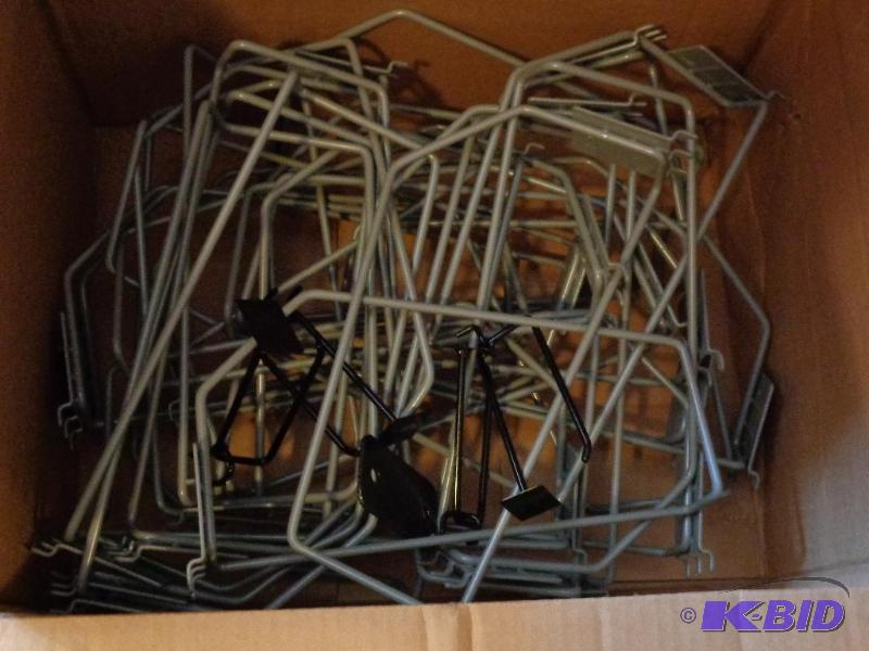 Assorted peg board hooks and merchandising ho...