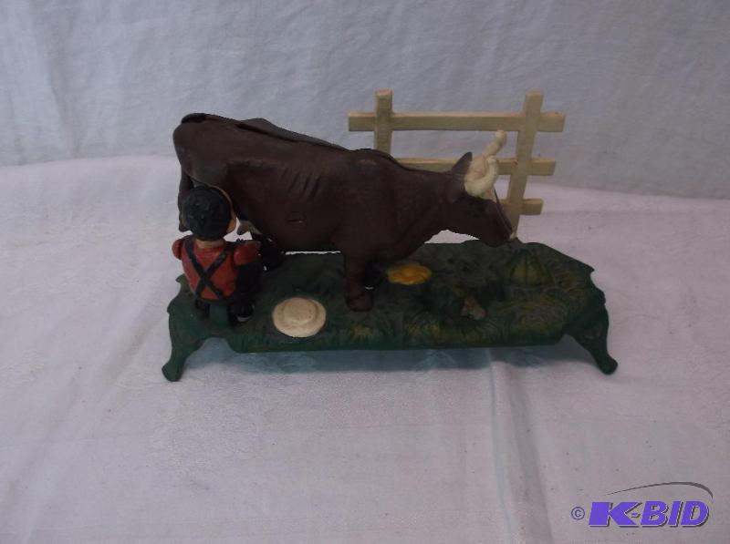 lot 82 image: Collectable mechanical cow bank measuring 9 1...
