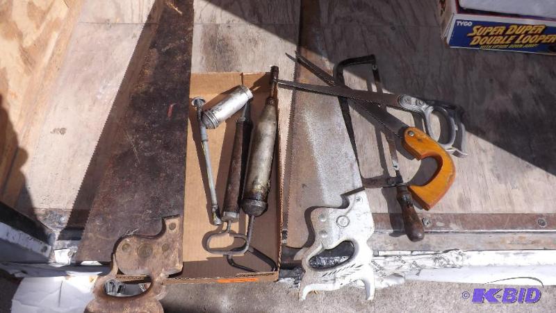 Lot of tools, old hand saws, old grease guns...
