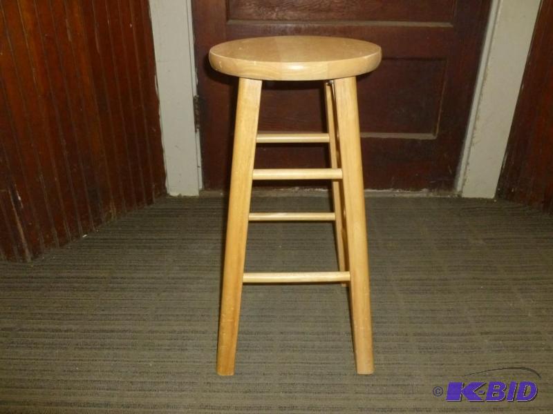 lot 62 image: Solid wood bar stool that measures 24.5"...