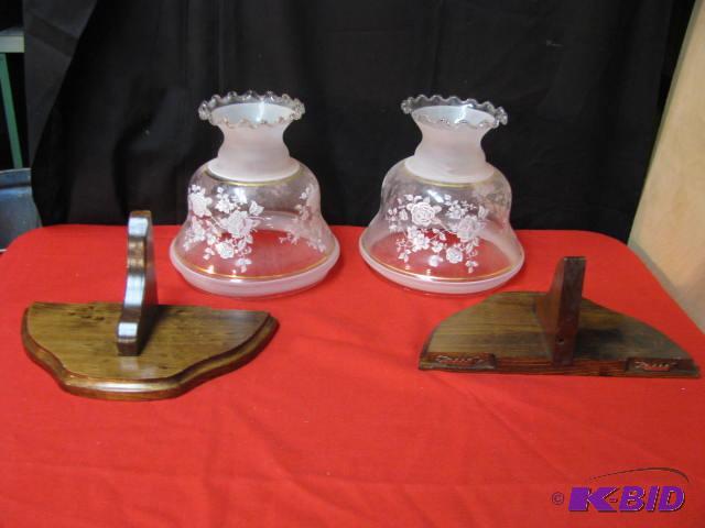 two glass lampshades and two wooden wall shel...