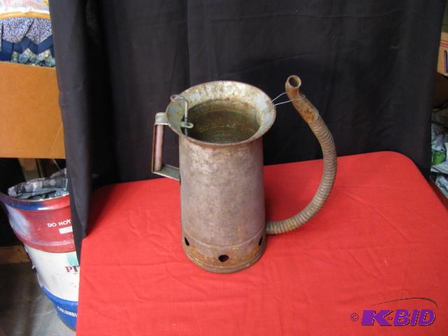 antique metal pouring container with a spout ...