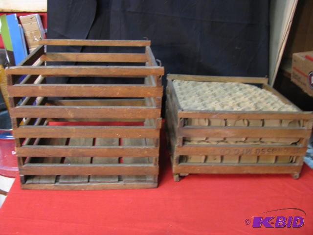 two vintage wooden egg crates one has the car...