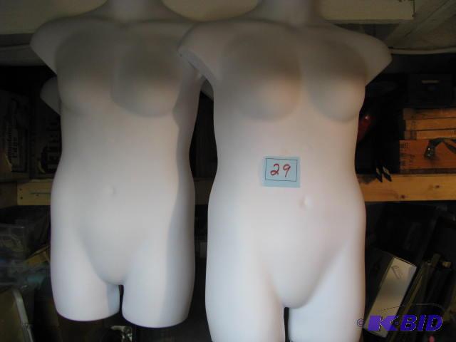two hanging white half body forms...