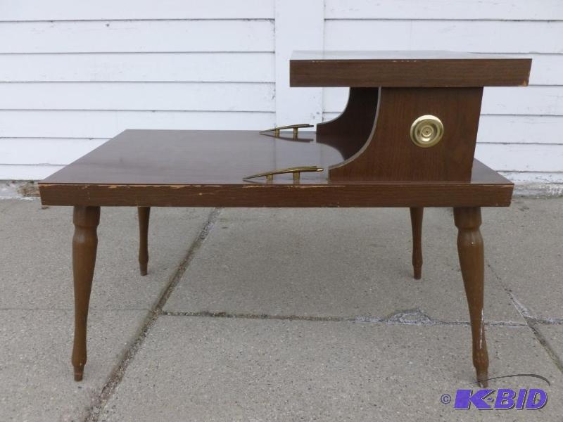 Vintage two tiered wooden end table that meas...