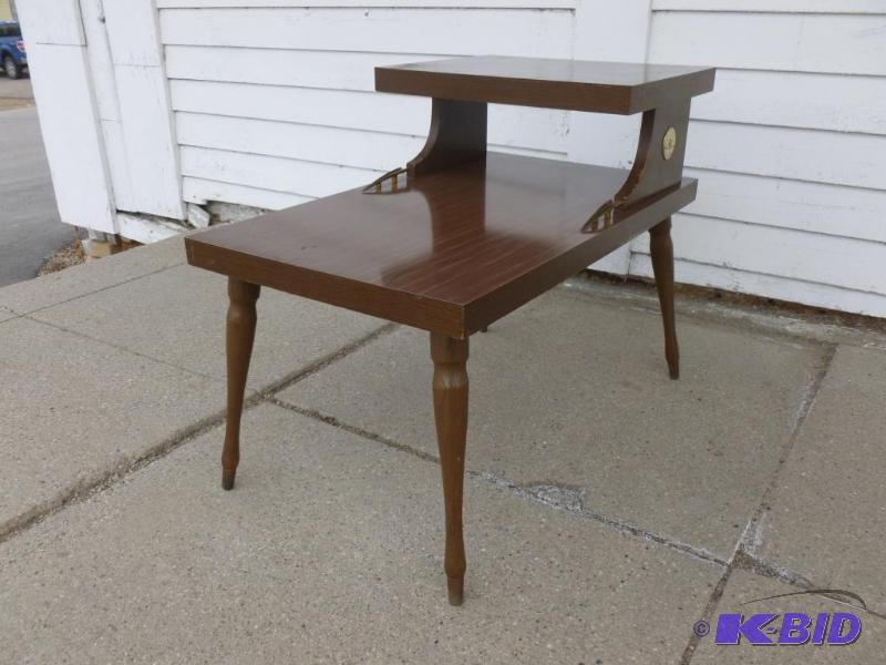 Vintage two tiered wooden end table that meas...
