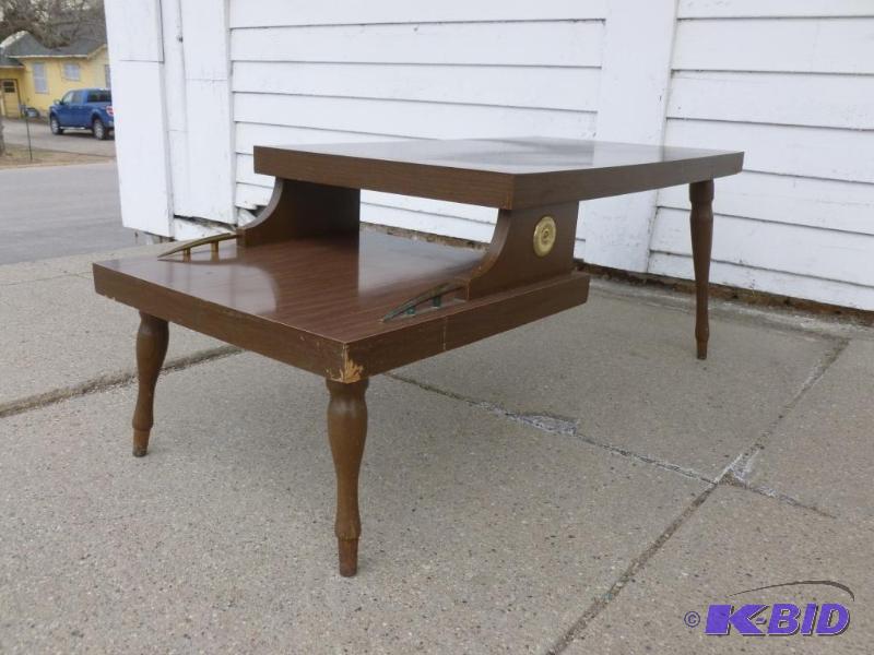 Vintage two tiered wooden end table that meas...
