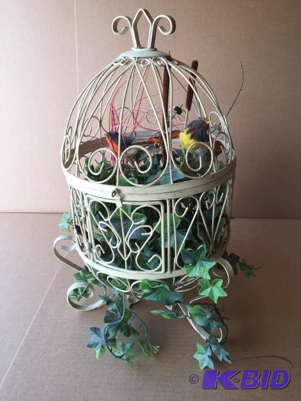 Bird cage with imitation plants and birds...