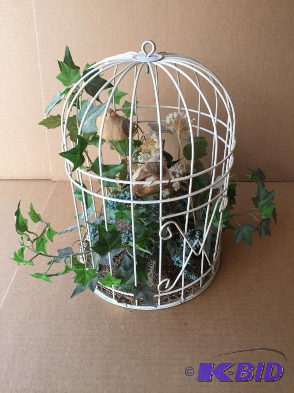 Bird cage with imitation plants and birds...