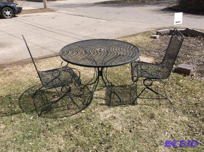 lot 46 image: Nice rod iron patio table with 2 rocking chai...