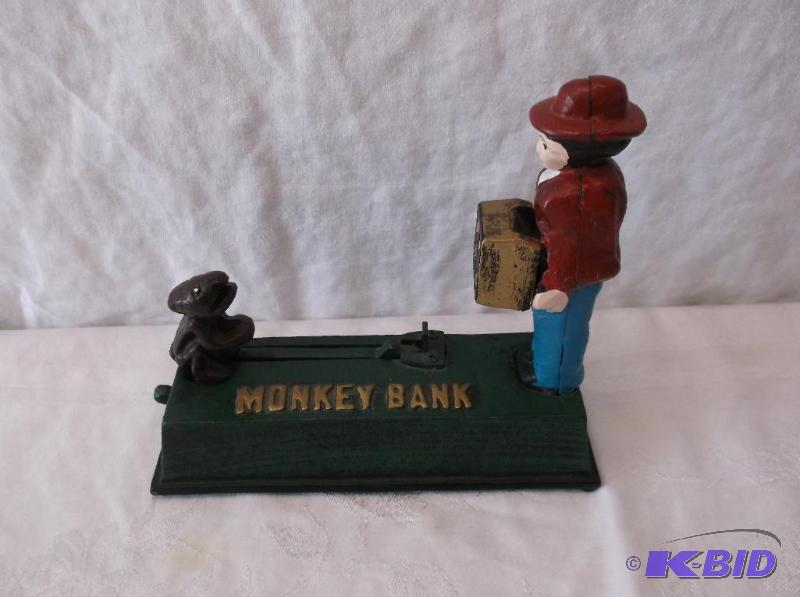 lot 52 image: Cast iron monkey bank measuring 7 12" L...