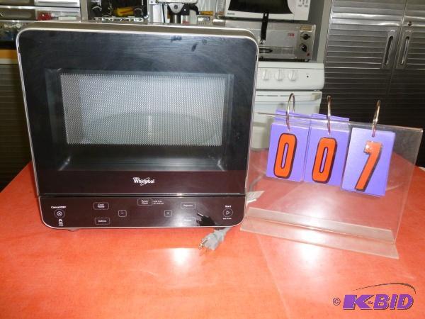 lot 7 image: Whirlpool compact microwave. Powers up. Teste...