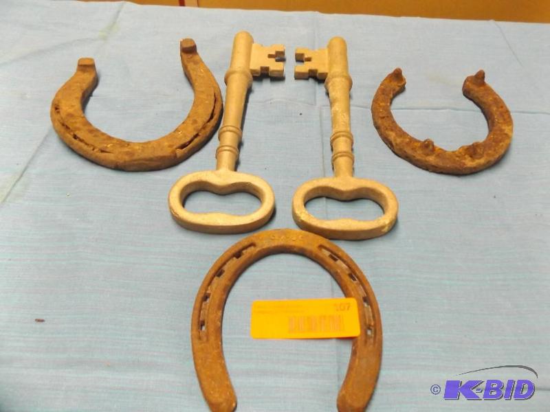 Three horse shoes and two decorative skeleton...
