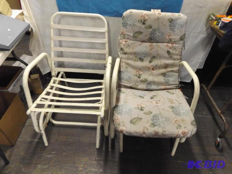 two lawn chairs, one has a cushion...