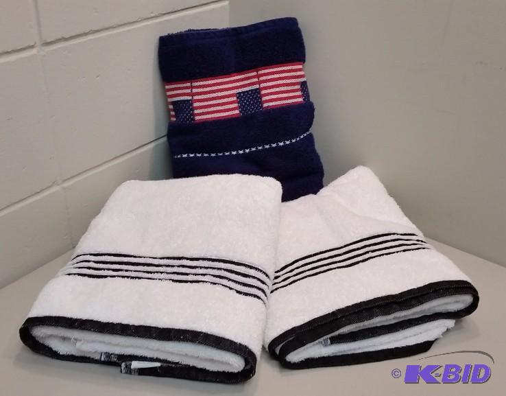 lot 26 image: 3 Bath Towels  Two White with Black Stripes and One Dark Blue Fourth of July themed.