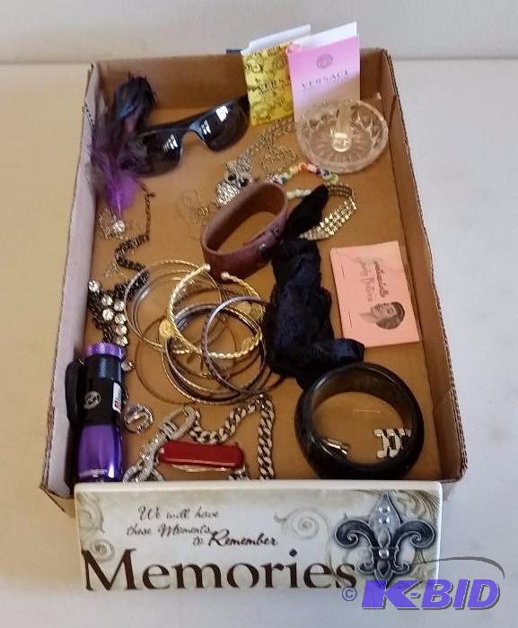 lot 34 image: Flat of Costume Jewelry, decorative items, sunglasses and belts.