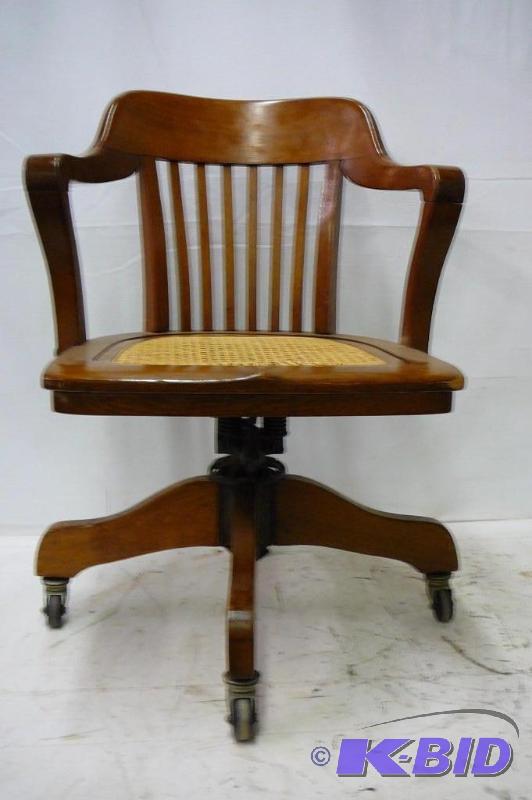 lot 8 image: vintage office chair with wicker bottom...