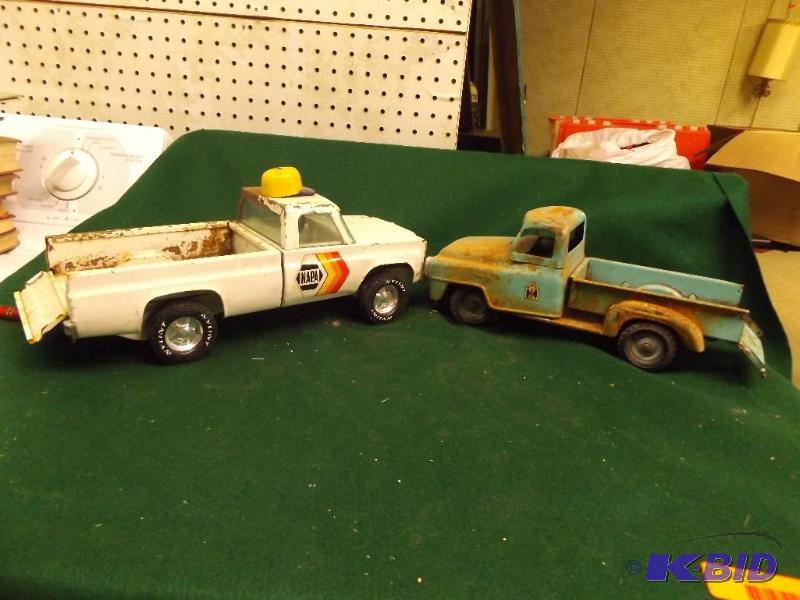 lot 88 image: Old metal trucks, one has NAPA sticker, one h...